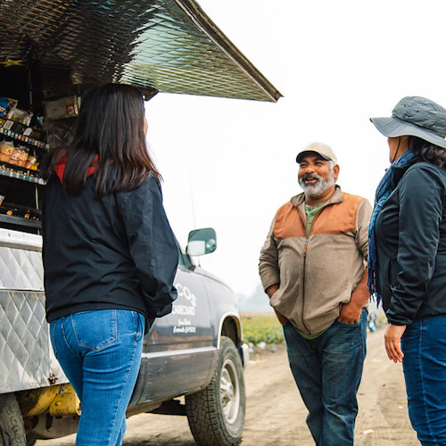 Instructors and a worker are talking at the food truck
