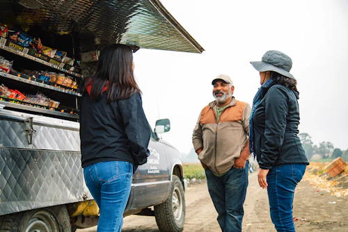 Instructors and a worker are talking at the food truck