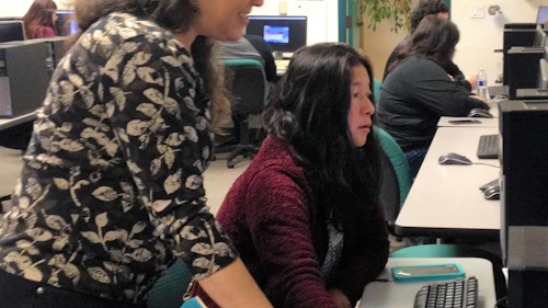 Tech and student looking at computer
