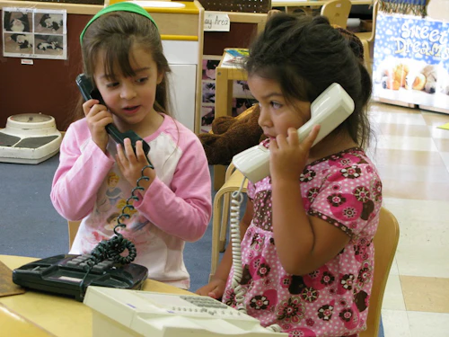 toddlers playing on the phone