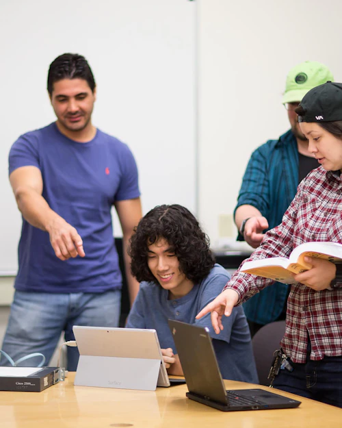 Cabrillo College Computer Information Systems Students Collaborating around a computer
