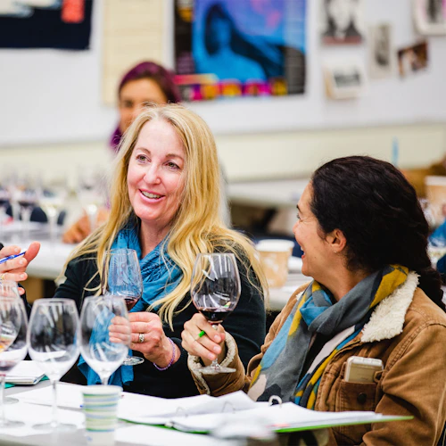 A couple people drinking wine