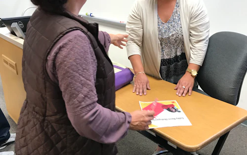 a math instructor talks and smiles with a student