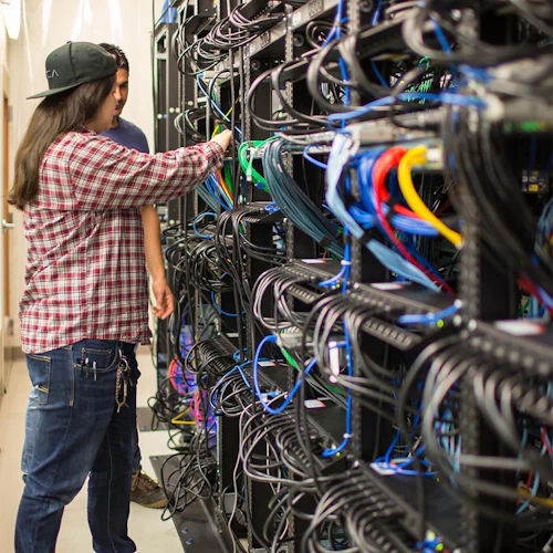 Cabrillo College Computer Information Systems Student working in a server room