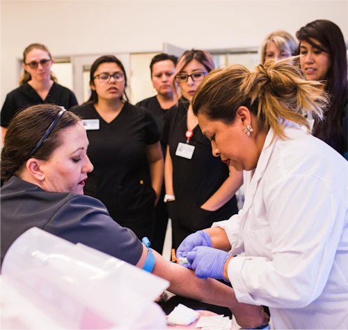 healthcare students and instructor with patient in clinical setting