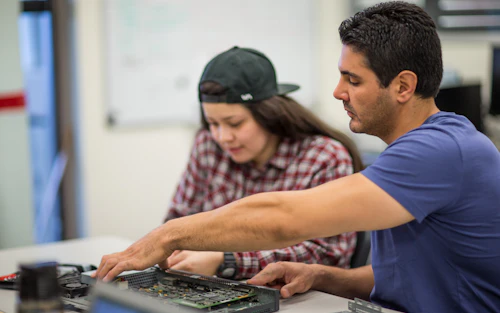 technology student and instructor working in classroom