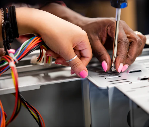 technology students working close up on wires and components