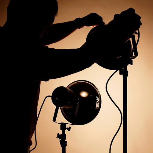 Student setting up lighting