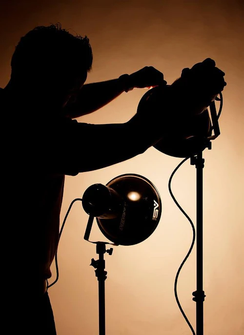 Student setting up lighting