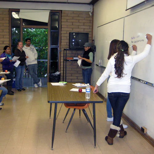 Students writing on board