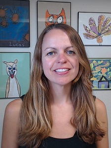 Aloha in her office with colorful children's art