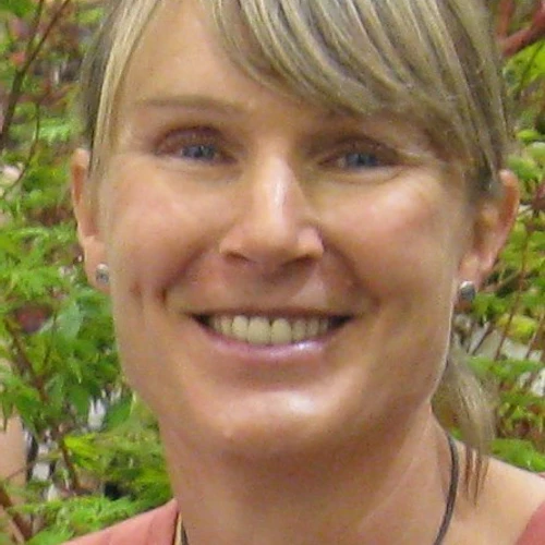 Nicky Hughes headshot with Japanese maples behind