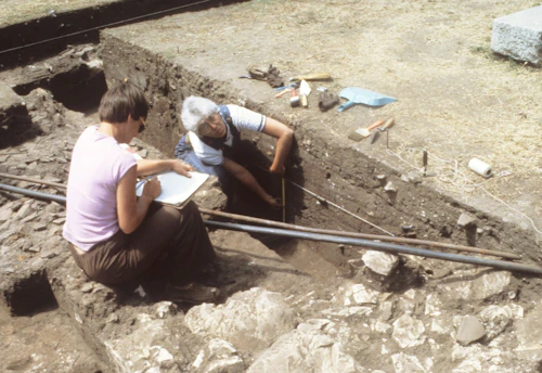 an archeology dig site with student and instructor