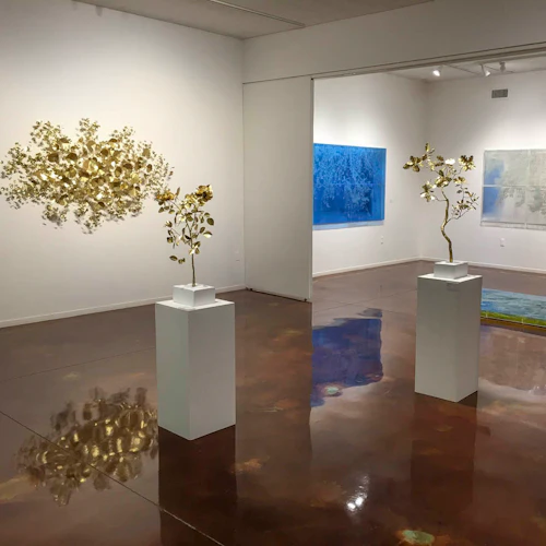 exhibition of airy works that are small metal leaves inserted directly into wall and paintings on plexiglas