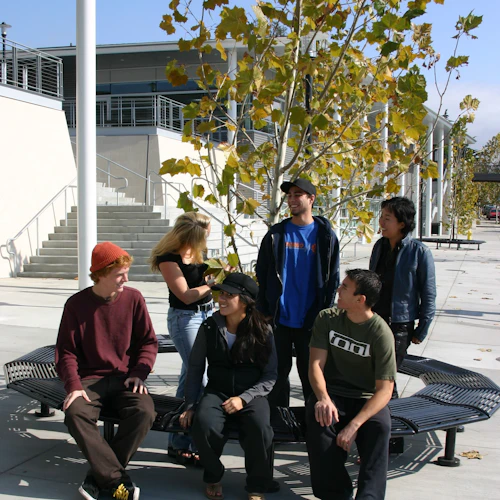 students sitting in front of the bookstore