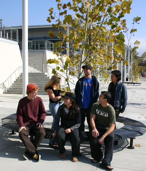 students sitting in front of the bookstore
