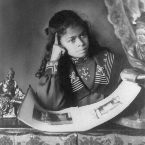 photography of an African American girl looking at a picture book