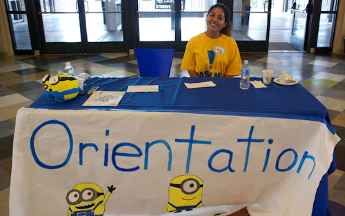 student sitting at orientation table