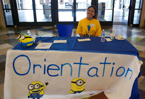 student sitting at orientation table