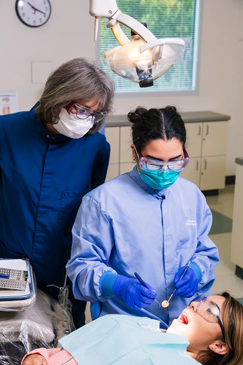 student working on a patient