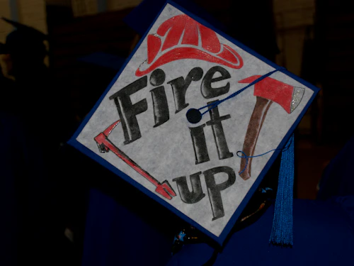 Decorative Image: grad cap with "fire it up" painted on top