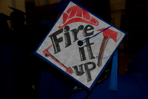 grad cap with "fire it up"