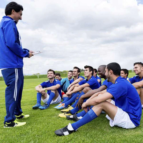 Coach teaching soccer players
