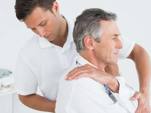 Male Chiropractor adjusting a patients back