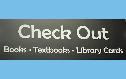 Check Out Desk sign at the Library