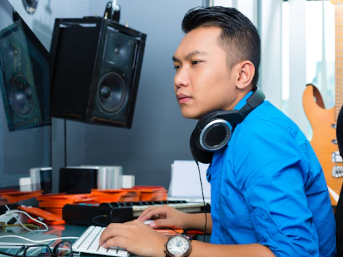 Músico, productor o mezclador asiático en estudio de sonido