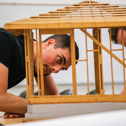 two students looking at a model in engineering class
