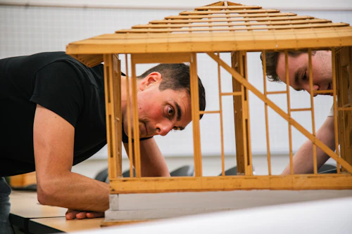 two students looking at a model in engineering class