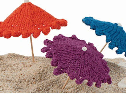 mini knit umbrellas in the sand