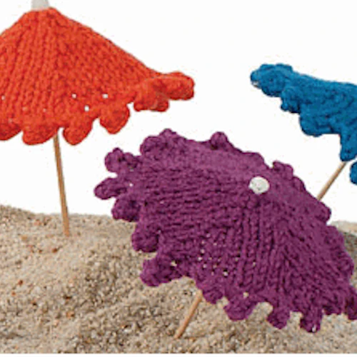 mini knit umbrellas in the sand
