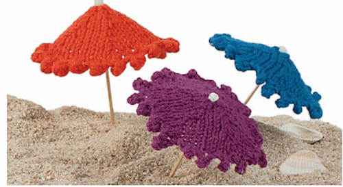 mini knit umbrellas in the sand