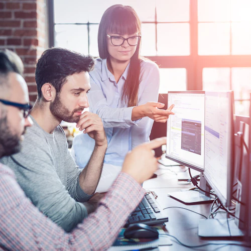 3 people working on a computer