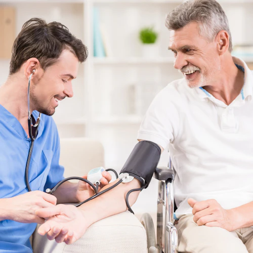 Male medical student taking a patient's blood pressure