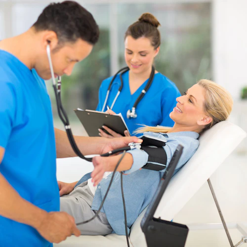 Medical Assistants taking a patients blood pressure