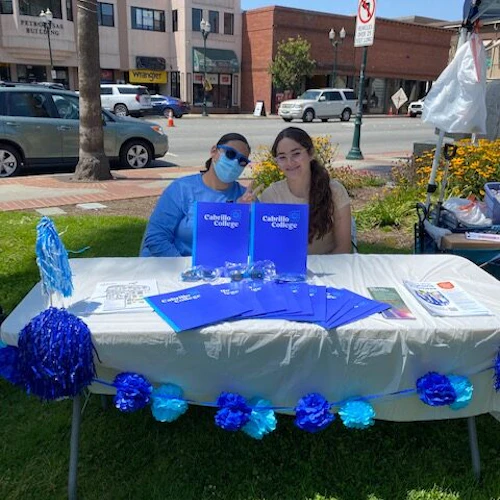 two girls sitting in plaza