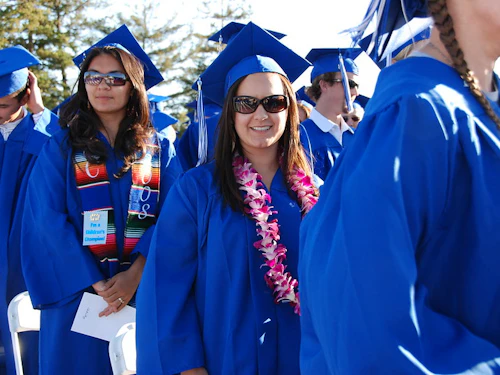 happy grads walking at ceremony