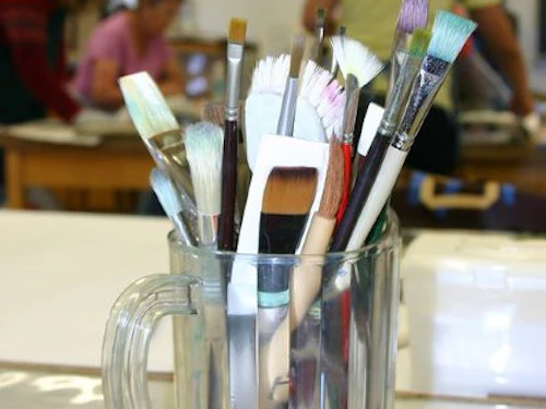 Decorative image: paint brushes in glass mug