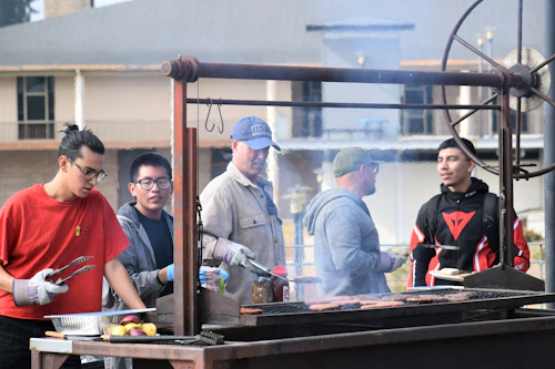 Staff and Student Assistants Cooking on the Grill at the Veterans Awareness Week BBQ