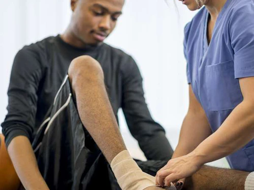 sports medicine physician evaluating an injury