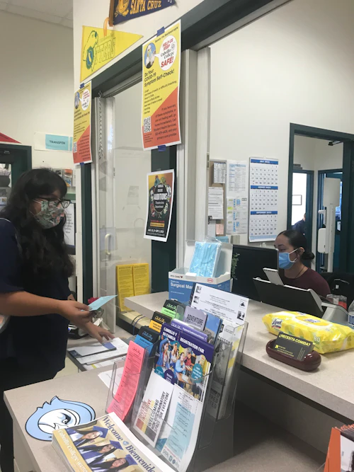 student being helped in front window