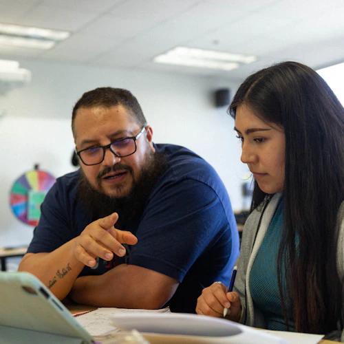 a math tutor helps explain math to a student