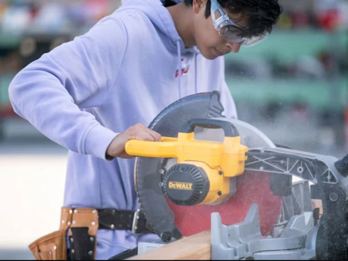 student working wtih electric saw