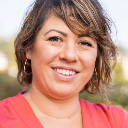 Yvonne Escalante headshot in a coral shirt