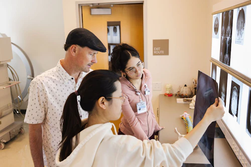 rad tech students with instructor looking at X-ray