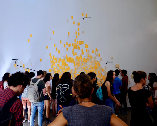 People stand in front of a wall map