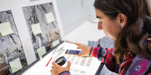 A student looks at photos in a lighbox